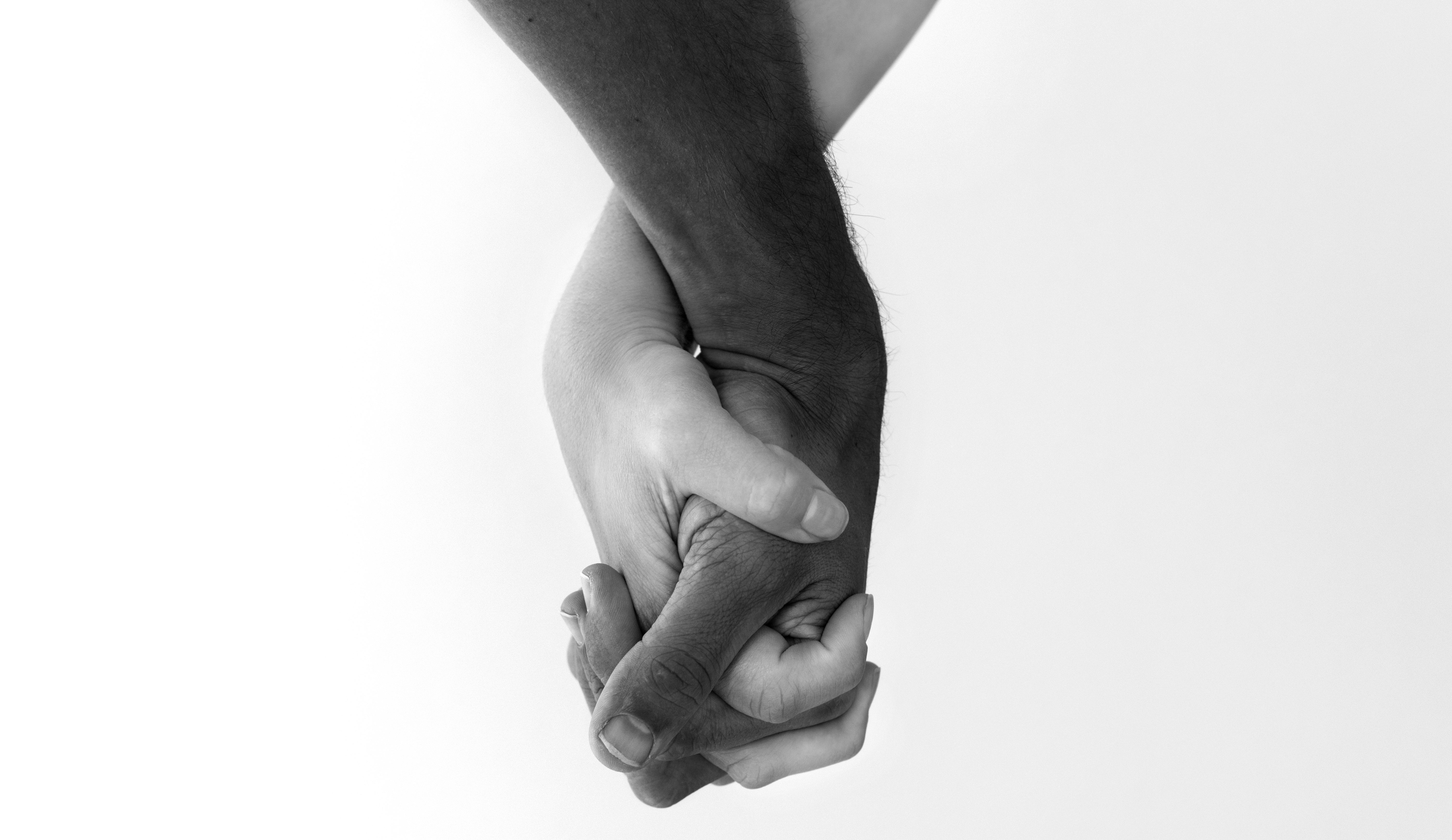 Multiracial couple holding hands.